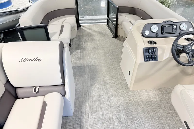 Slide: The Image of Interior of 2026 Bentley Pontoons LE 160 CR, featuring luxurious seating and modern dashboard. - 13
