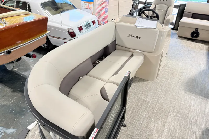 Slide: The Image of 2026 Bentley Pontoons LE 160 CR interior with luxurious seating and steering console. - 12