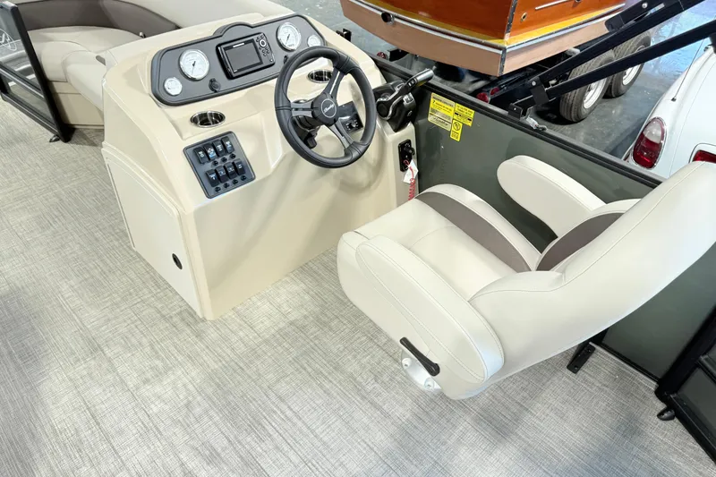 Slide: The Image of 2026 Bentley Pontoons LE 160 CR helm with steering wheel and control panel. - 10