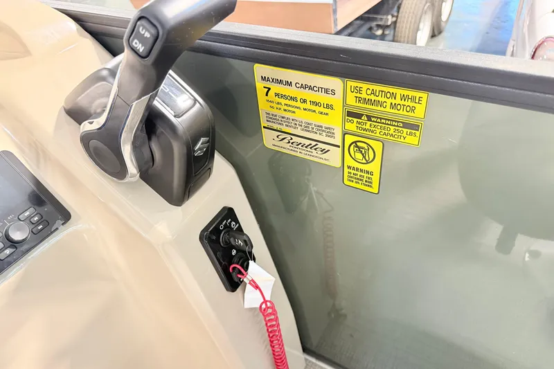 Slide: The Image of Control panel of 2026 Bentley Pontoons LE 160 CR with safety warnings and throttle lever. - 7