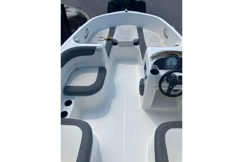 Slide: The Image of 2018 Bayliner Element E16 boat interior with seating and steering console. - 6