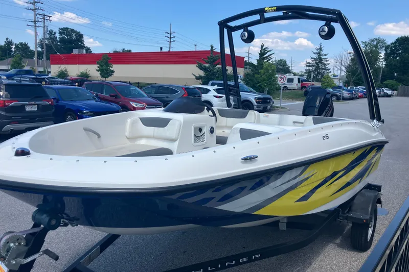 Slide: The Image of 2018 Bayliner Element E16 boat on trailer in parking lot, featuring sleek design and vibrant graphics. - 3