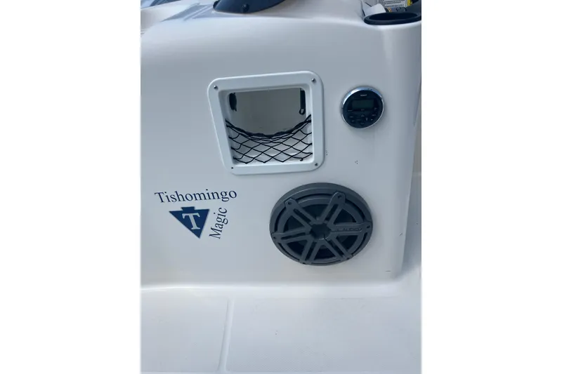Slide: The Image of 2018 Bayliner Element E16 boat interior with speaker and storage compartment. - 11