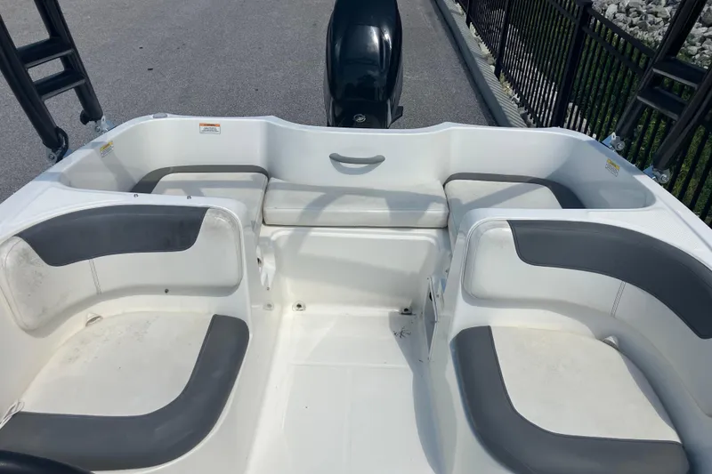 Slide: The Image of 2018 Bayliner Element E16 boat interior with gray and white seating arrangement. - 8