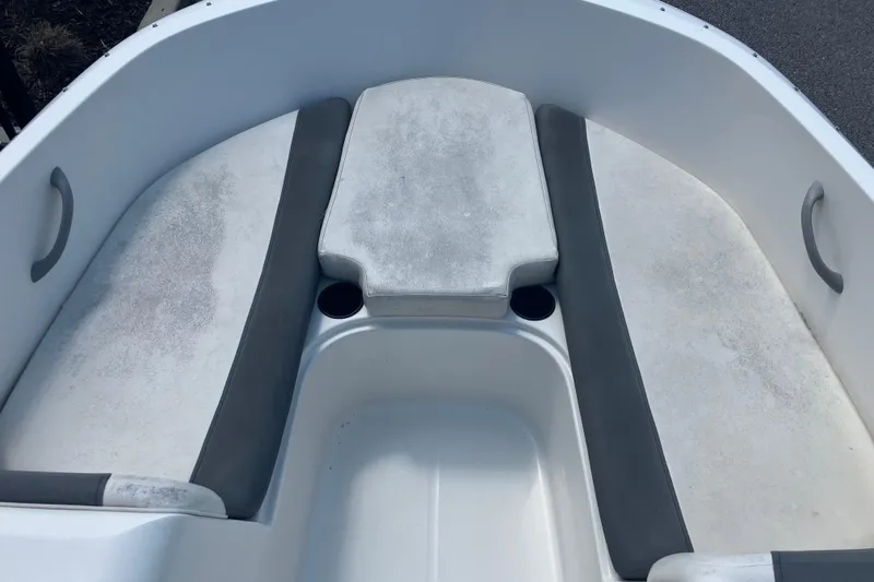 Slide: The Image of 2018 Bayliner Element E16 boat interior with cushioned seating and cup holders. - 7