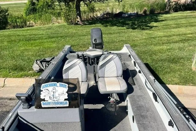 Slide: The Image of 1995 Bass Tracker Pro 17 boat with dual seats, parked on grass. - 8