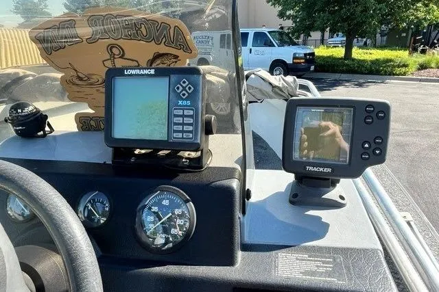 Slide: The Image of 1995 Bass Tracker Pro 17 dashboard with Lowrance X65 and Tracker fish finders. - 9