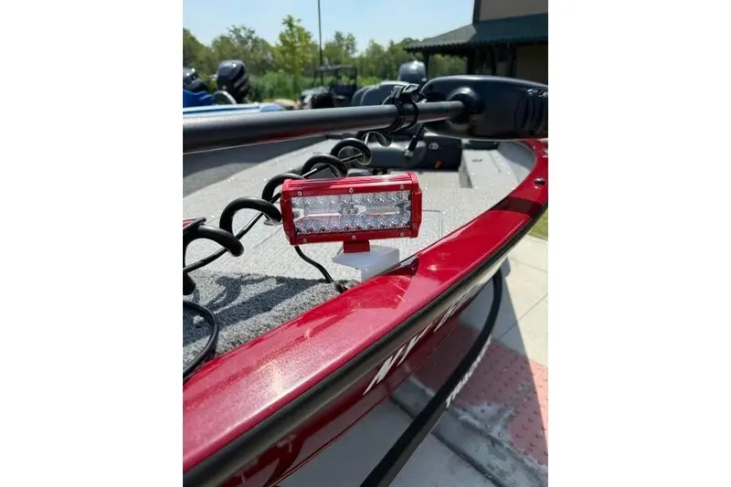 Slide: The Image of Red 2021 Tracker Super Guide V-16 T boat with mounted LED light on deck. - 11