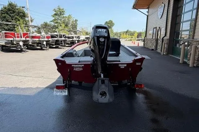 Slide: The Image of 2021 Tracker Super Guide V-16 T boat with outboard motor in parking lot. - 3