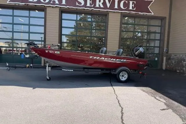 The Image of 2021 Tracker Super Guide V-16 T boat parked outside a boat service center. - 1