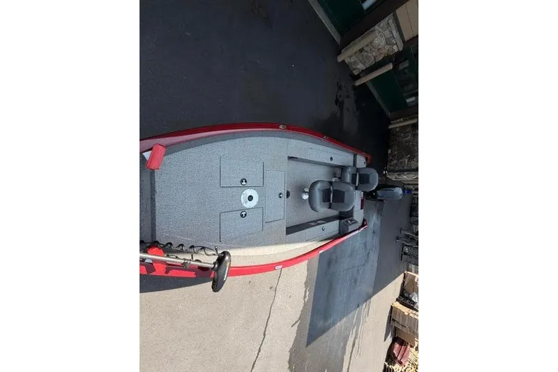 Slide: The Image of 2021 Tracker Super Guide V-16 T fishing boat with red trim, parked outdoors. - 4