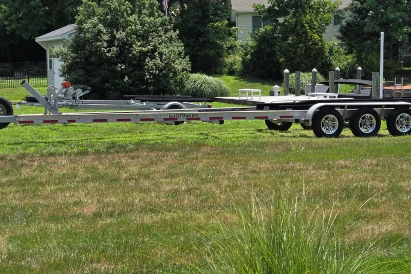 Slide: The Image of 2019 Glasstream 328 SCX trailer on grassy lawn, surrounded by trees and a house. - 15