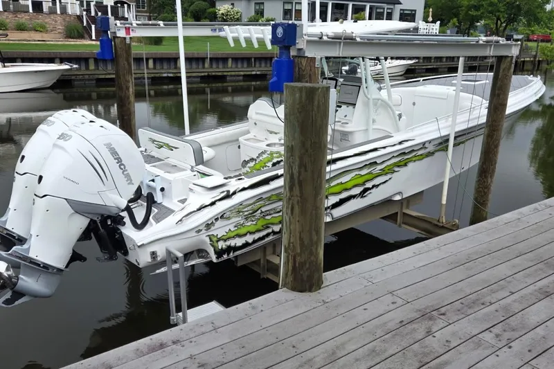 Slide: The Image of 2019 Glasstream 328 SCX boat docked, featuring vibrant green and black graphics. - 2