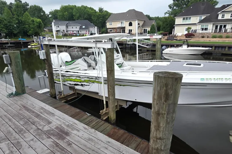 The Image of 2019 Glasstream 328 SCX boat docked in a residential marina setting. - 1