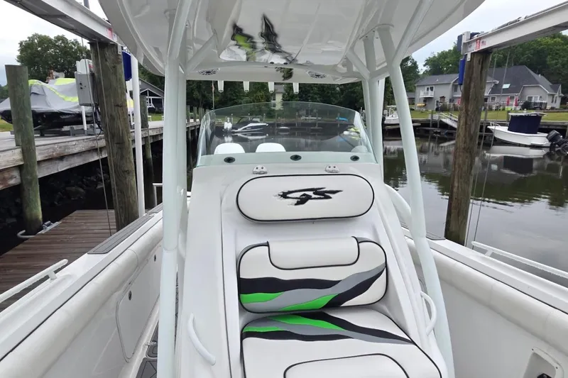 Slide: The Image of 2019 Glasstream 328 SCX boat interior with stylish seating at a marina. - 9