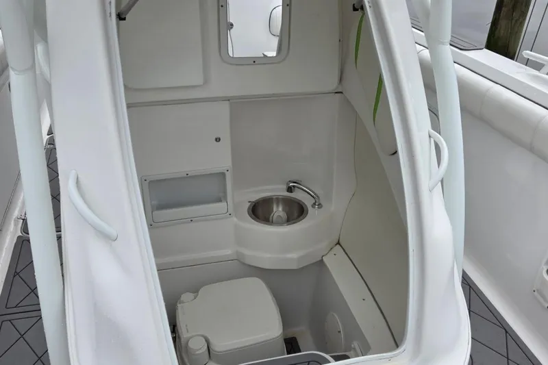 Slide: The Image of 2019 Glasstream 328 SCX boat interior with compact bathroom and sink. - 10