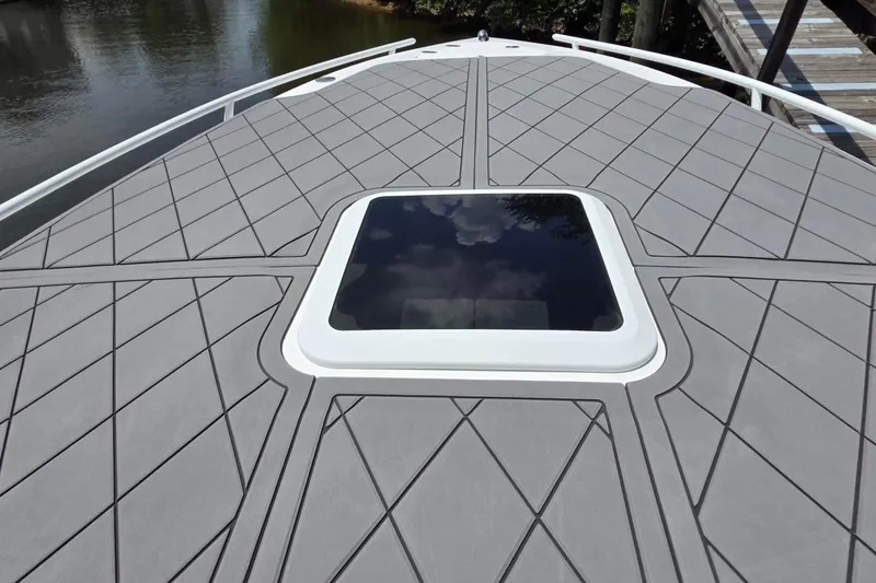 Slide: The Image of 2019 Glasstream 328 SCX boat deck with sleek design and central hatch. - 12