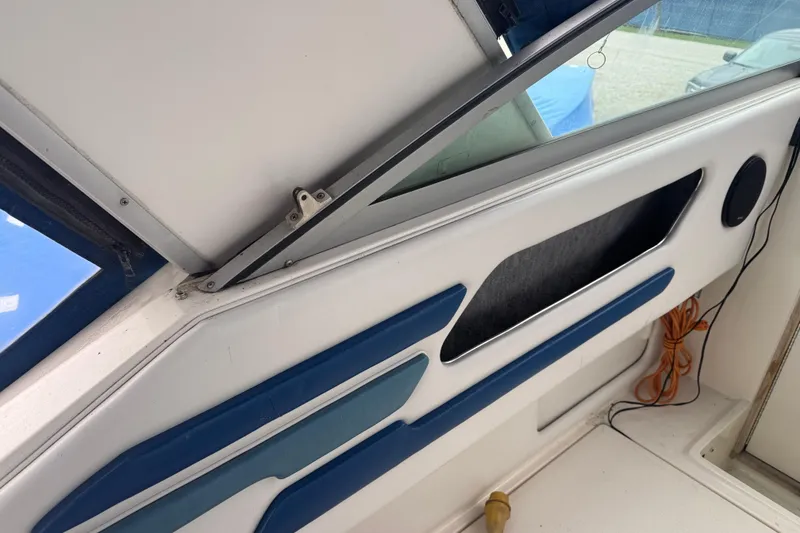 Slide: The Image of Interior view of a 1993 Sea Ray Sundancer 330 boat with blue accents. - 10
