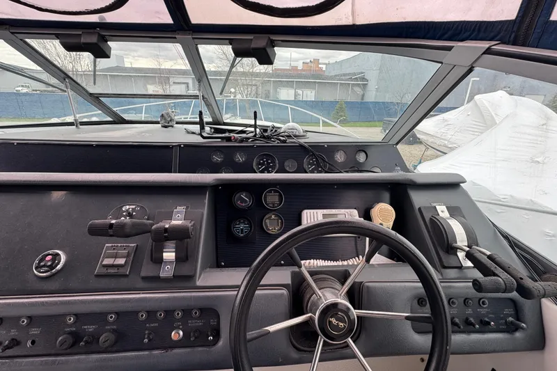Slide: The Image of Cockpit view of a 1993 Sea Ray Sundancer 330 boat with steering wheel and control panel. - 7