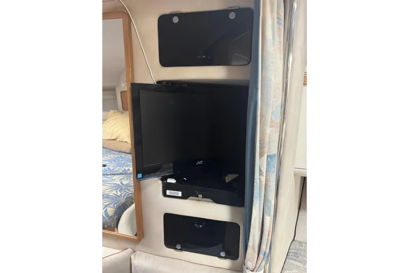 Slide: The Image of Interior of 1993 Sea Ray Sundancer 330 with mounted JVC TV and patterned bedding. - 16