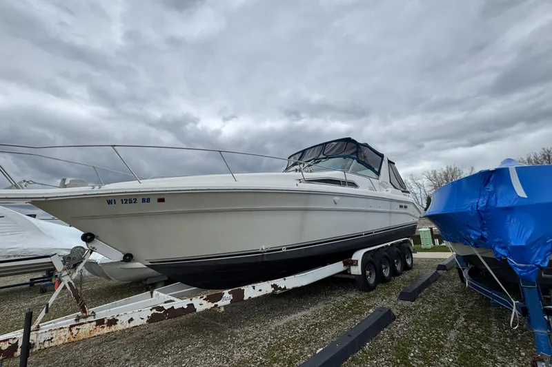 Slide: The Image of 1993 Sea Ray Sundancer 330 boat on trailer under cloudy sky. - 1