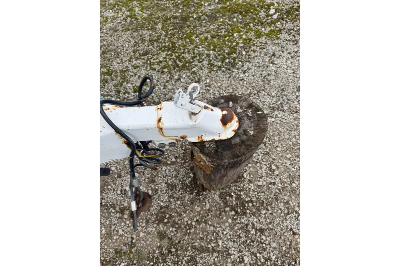 Slide: The Image of Rusty trailer hitch on gravel, related to 1993 Sea Ray Sundancer 330 boat. - 4