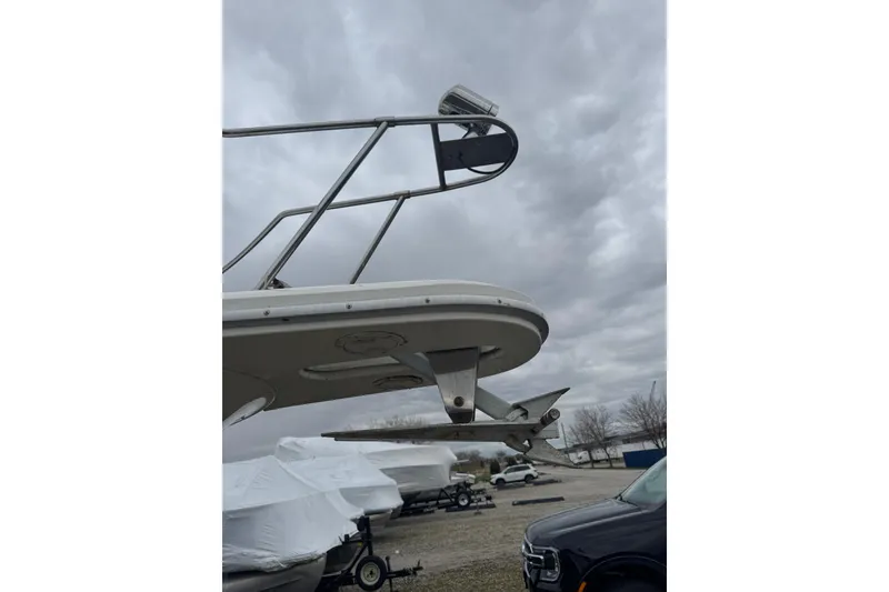 Slide: The Image of Bow view of 1993 Sea Ray Sundancer 330 under cloudy skies in a boatyard. - 6