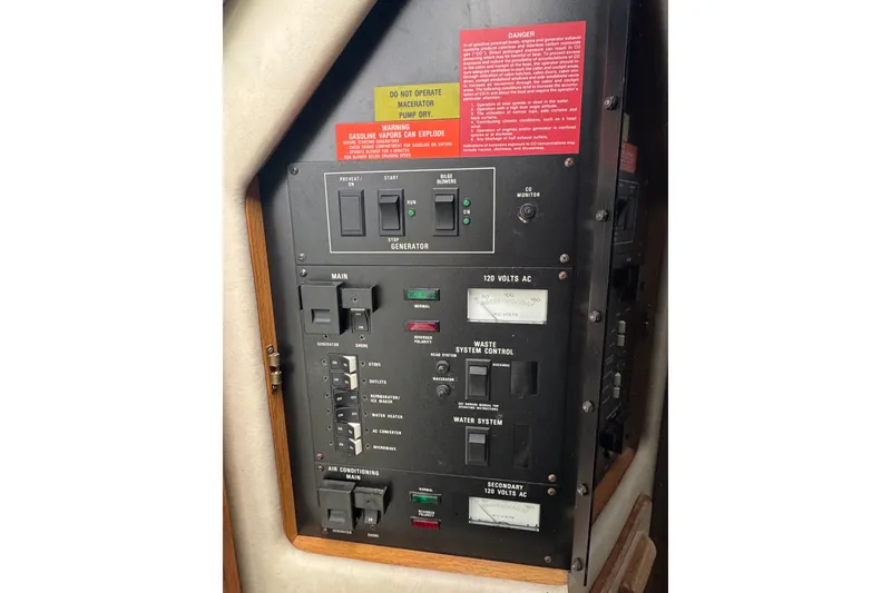 Slide: The Image of Electrical control panel of 1993 Sea Ray Sundancer 330 boat with warning labels. - 23
