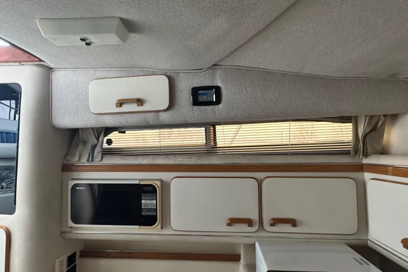 Slide: The Image of Interior of a 1993 Sea Ray Sundancer 330 with cabinets and a microwave. - 20