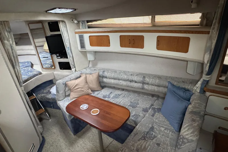 Slide: The Image of Interior of 1993 Sea Ray Sundancer 330 yacht with cozy seating and wooden table. - 24