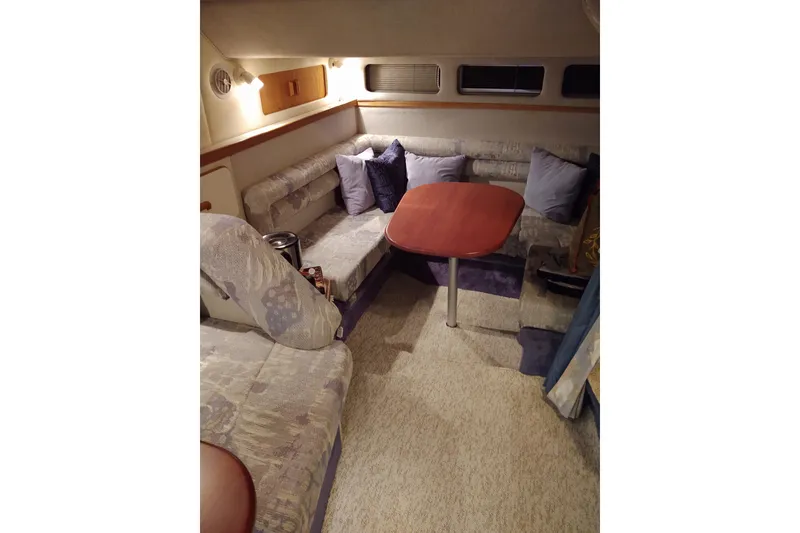 Slide: The Image of Interior of 1993 Sea Ray Sundancer 330 with cozy seating and wooden table. - 27