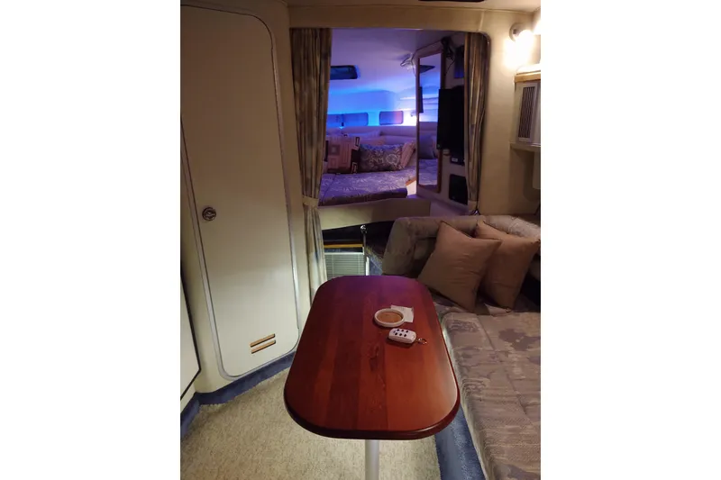 Slide: The Image of Interior of 1993 Sea Ray Sundancer 330 yacht with cozy seating and ambient lighting. - 25