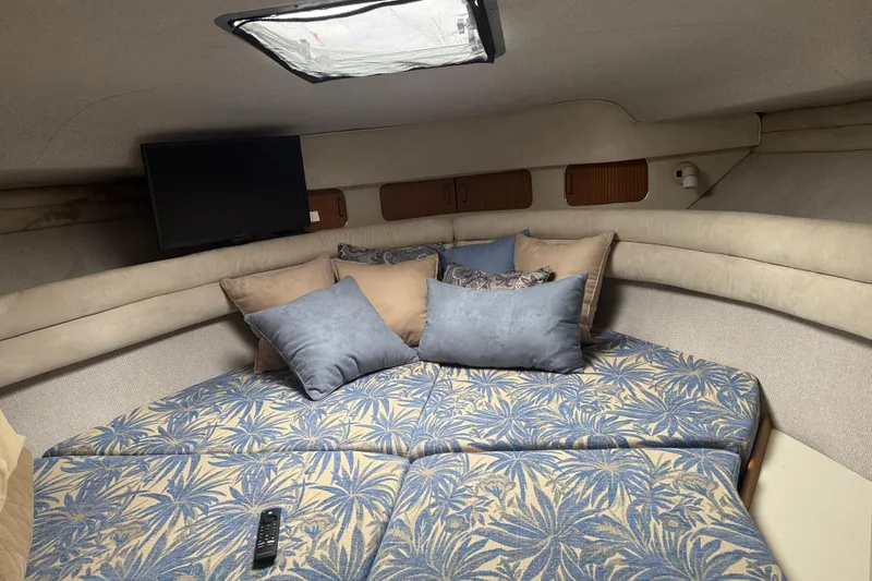 Slide: The Image of Cozy cabin interior of 1993 Sea Ray Sundancer 330 with patterned bedding and pillows. - 15