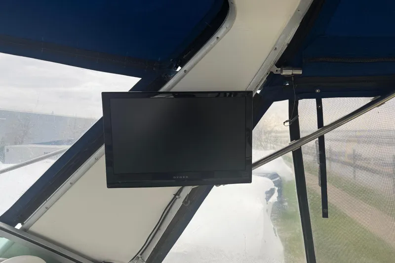 Slide: The Image of Mounted TV inside 1993 Sea Ray Sundancer 330 boat with blue canopy. - 11