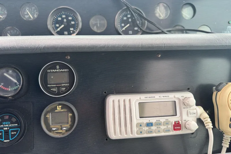 Slide: The Image of 1993 Sea Ray Sundancer 330 dashboard with gauges and marine radio equipment. - 9