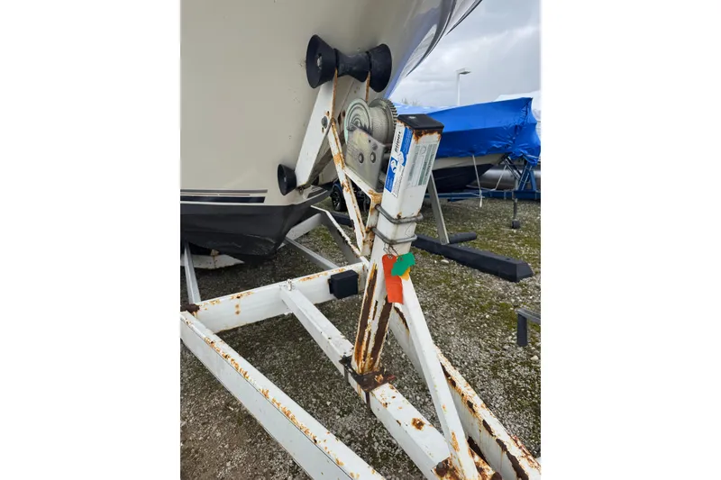 Slide: The Image of 1993 Sea Ray Sundancer 330 on a rusty trailer, parked outdoors. - 5