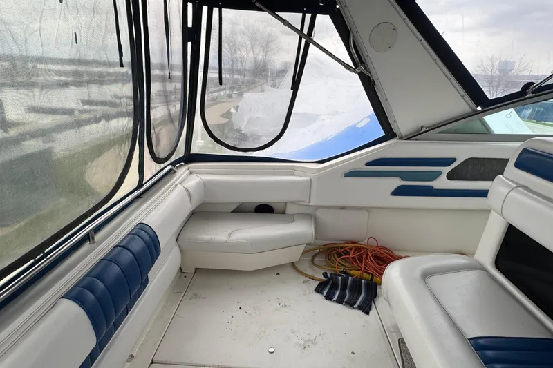 Slide: The Image of Interior of a 1993 Sea Ray Sundancer 330 boat with blue and white seating. - 30