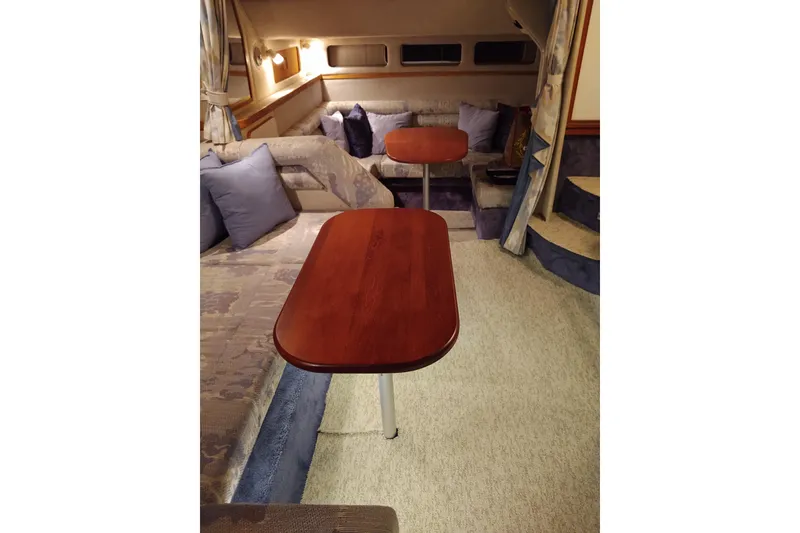 Slide: The Image of Interior of 1993 Sea Ray Sundancer 330 with cozy seating and wooden tables. - 26