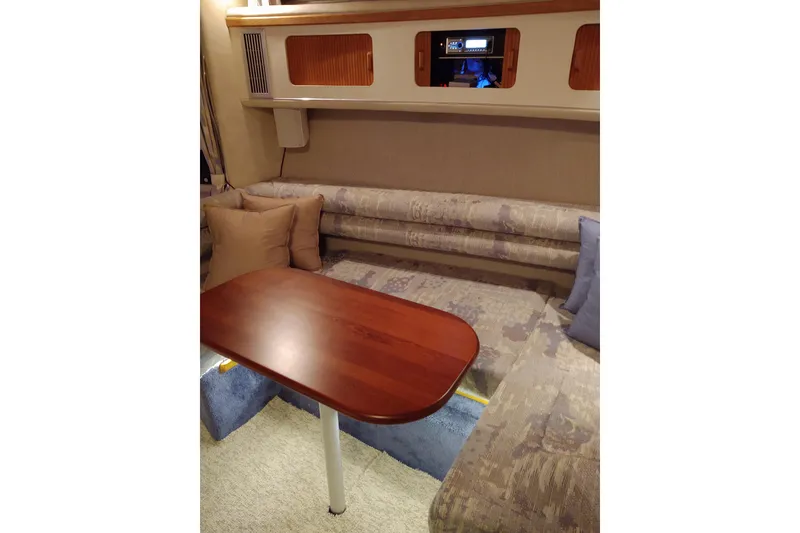 Slide: The Image of Interior of 1993 Sea Ray Sundancer 330 with cozy seating and wooden table. - 28
