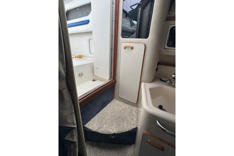 Slide: The Image of Interior view of 1993 Sea Ray Sundancer 330 boat, featuring cabin and sink area. - 22