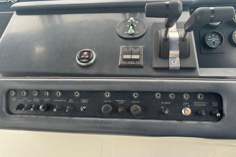 Slide: The Image of Control panel of a 1993 Sea Ray Sundancer 330 boat with various switches and levers. - 8