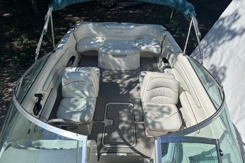 Slide: The Image of Interior view of a 1998 Sea Ray 260 Signature boat with white seating. - 8