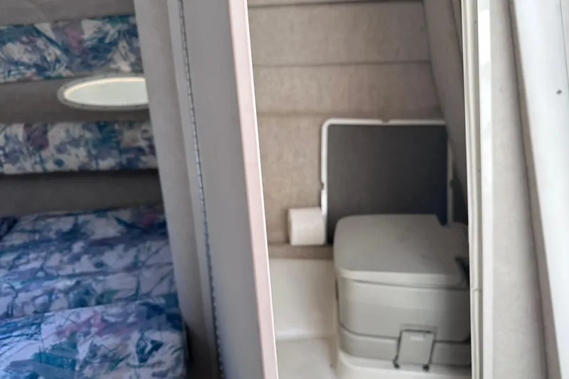 Slide: The Image of Interior of 1998 Sea Ray 260 Signature boat showing cabin and compact toilet area. - 21