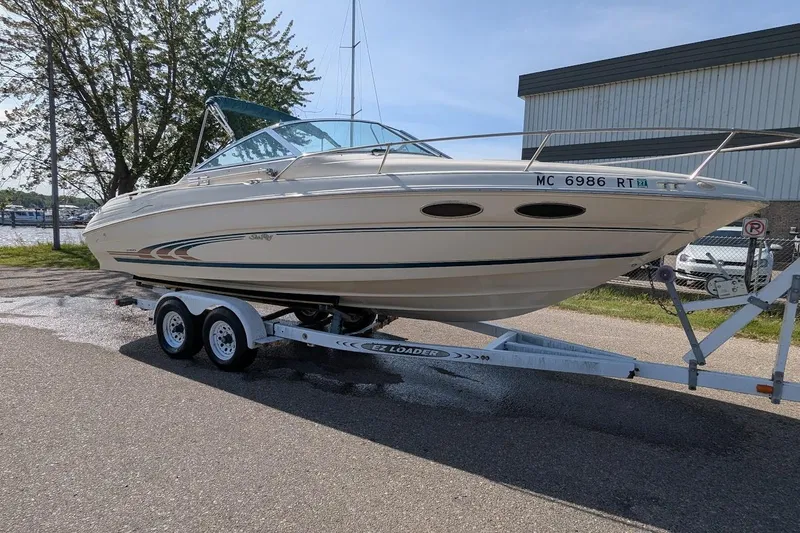 Slide: The Image of 1998 Sea Ray 260 Signature boat on trailer, parked outdoors near marina. - 1