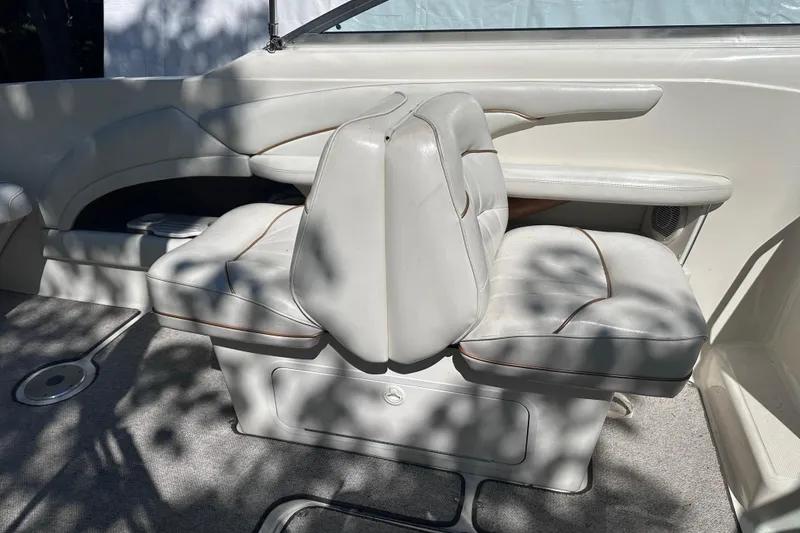 Slide: The Image of 1998 Sea Ray 260 Signature boat interior with white leather seating and carpeted floor. - 15