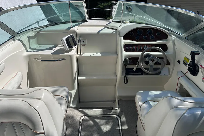 Slide: The Image of Interior of a 1998 Sea Ray 260 Signature boat with steering wheel and dashboard. - 10