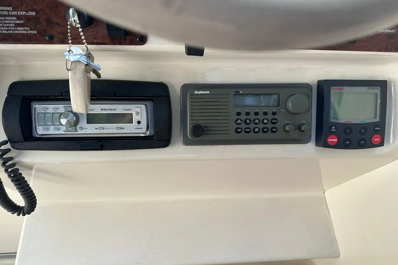 Slide: The Image of Control panel of a 1998 Sea Ray 260 Signature boat with radio and navigation equipment. - 13