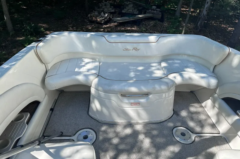 Slide: The Image of 1998 Sea Ray 260 Signature boat interior with white seating and carpeted floor. - 16