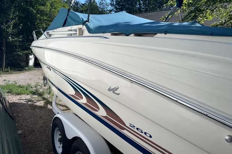 Slide: The Image of 1998 Sea Ray 260 Signature boat with blue cover on trailer. - 6