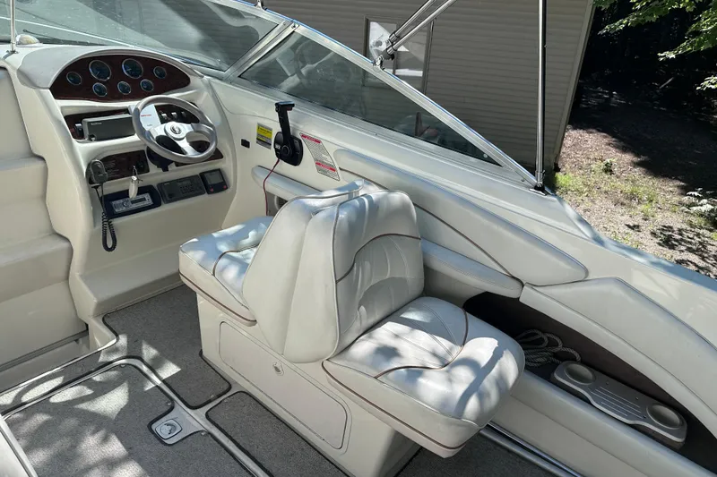 Slide: The Image of 1998 Sea Ray 260 Signature boat interior with steering wheel and seating. - 17